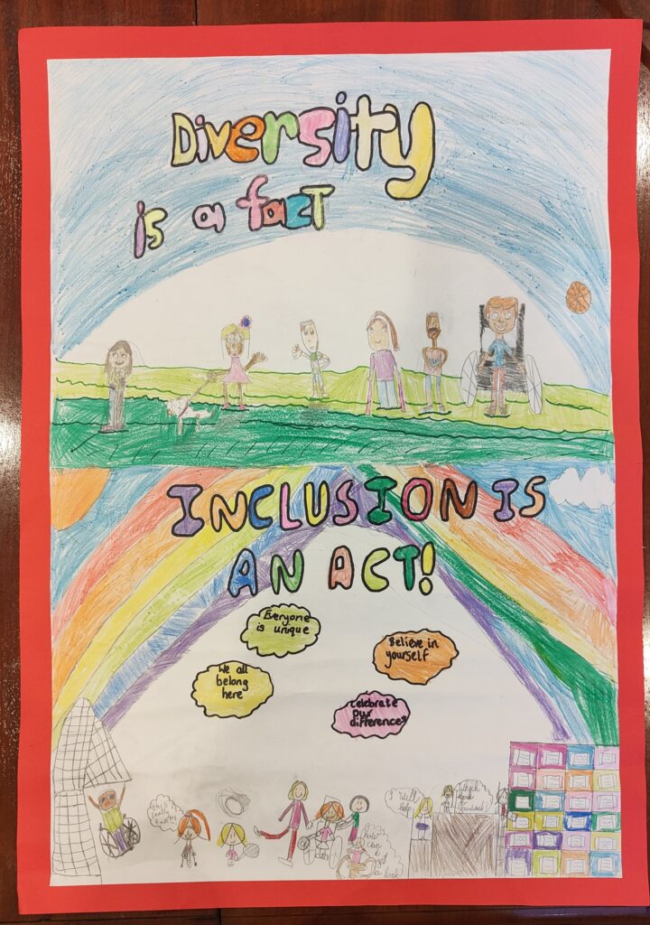 A cardboard with a child's drawing of a rainbow, people and self-esteem messages