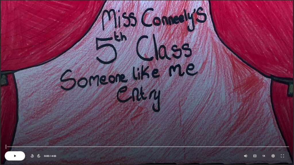 Still image of a drawing on a red background with the caption Ms. Conneely's 5th class entry to Someone Like Me, showcasing creativity and inclusion.